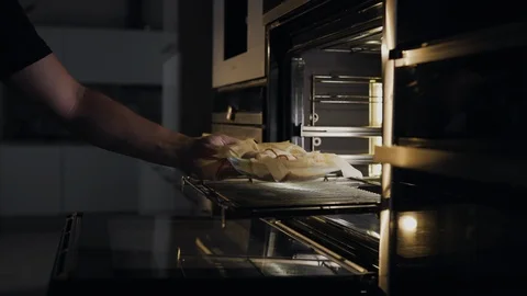 Chef puts rolls with bacon and chicken to the oven for roasting, cooking meat Video stock 114423220