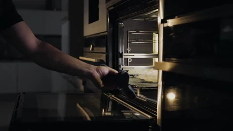 Chef puts rolls with bacon and chicken to the oven for roasting Stock Footage 143779265