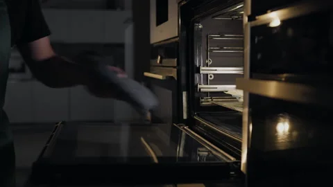 Chef puts rolls with bacon and chicken to the oven for roasting Stock Footage 143779305