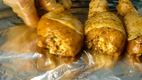 Chef puts in a row raw chicken legs in marinade. Stock Footage 131370783