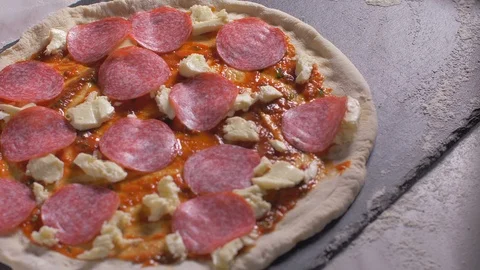 Chef puts salami on the pizza. Slow motion Stock Footage 106345804