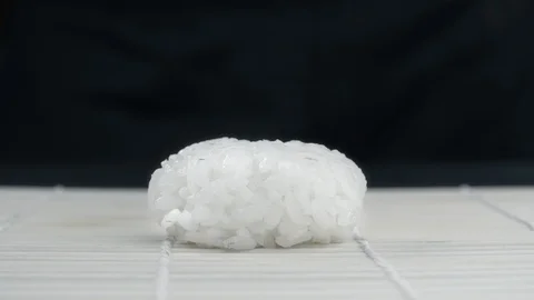 Chef puts salmon slice to the rice, making the nigiri in slow motion, cooking Stock Footage 116609343