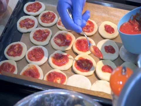 The chef puts the sauce on the dough Stock Footage 81300318