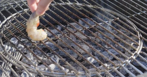 Chef puts shrimp on the grill Stock Footage 107325903
