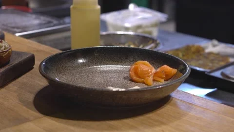The chef puts sliced red fish on a plate. Serving the festive table. Restaurant Stock Footage 171682477