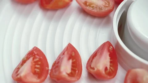 Chef puts slices of ripe red tomatoes on a pallet in vegetable dryer. close up. Stock Footage 277942507