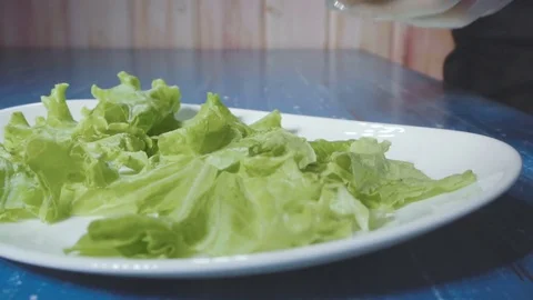 Chef puts steak on a plate with salad Stock Footage 73816402