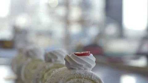 Chef puts strawberry slice on whipped cream, cake covered with shredded coconut Stock Footage 158125291