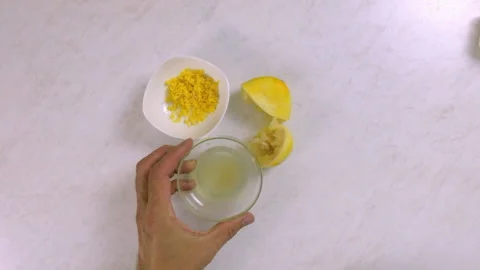 Chef puts on table lemon rind, squeezed lemon and lemon juice Stock Footage 99542798