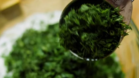 The chef puts a tablespoon of chopped dill in the ingredients for the ranch Stock-Footage 196981127