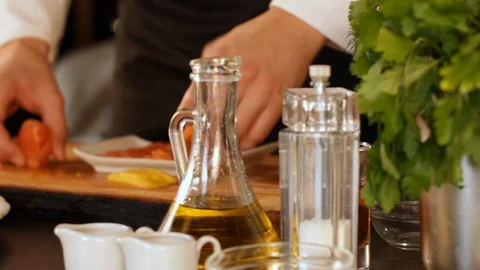 Chef puts thin sliced, slightly salted salmon on a plate of green salad leaves Stock Footage 116685368