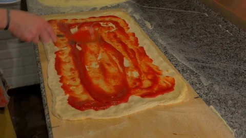 Chef puts tomato on a big pizza Stock Footage 85007496