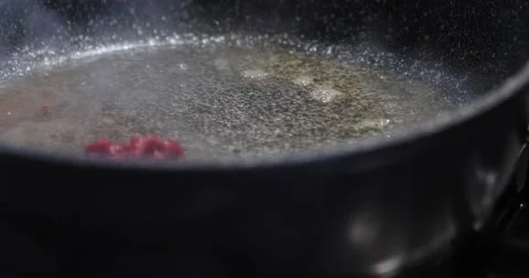 Chef puts tomato paste in frying pan with boiling oil Stock-Footage 160885270