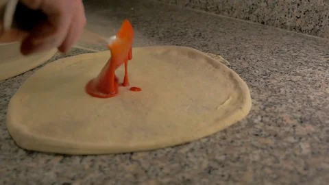 Chef puts tomato sauce on pizza Stock Footage 85007525