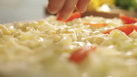 Chef puts tomatoes on the pizza, preparing the pizza Stock Footage 130558595