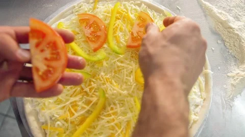 Chef puts tomatoes on the pizza, preparing the pizza Stock Footage 150114343