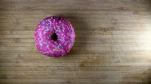 A chef puts two donuts next to each other filling on a wooden table slow Stock Footage 261856344