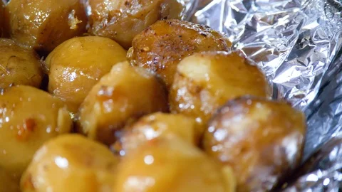 The chef puts vegetables on the dish cooked in a cauldron. Kazan kebab Stock Footage 124731730