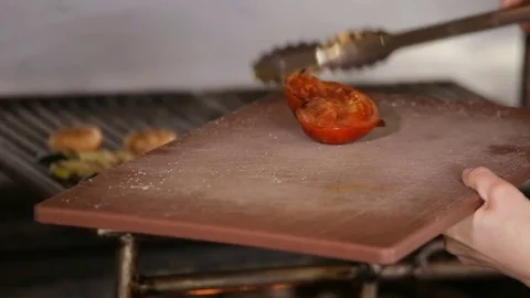 Chef puts vegetables from grill to board Stock Footage 74716110