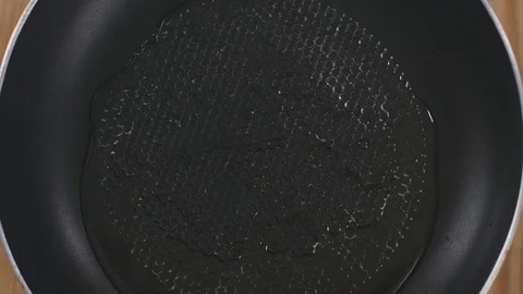 The chef puts vegetables on a heated frying pan Stock Footage 82473637
