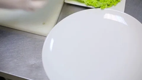Chef puts the vegetables on a plate Stock Footage 70171852
