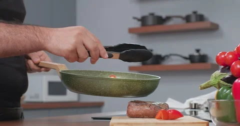 Chef puts vegetables on the steak board. Cooking at home. Slow motion Stock Footage 261749158
