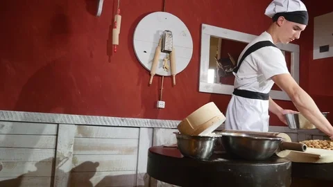 Chef putting apple to pie in restaurant kitchen Stock Footage