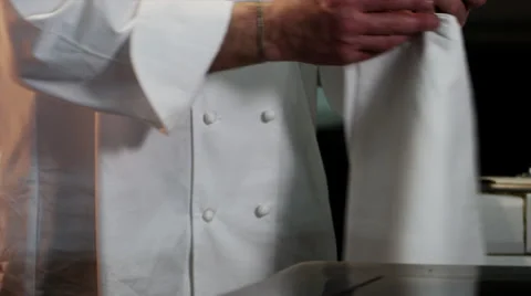 CHEF PUTTING ON APRON Stock Footage 30002859