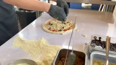 Chef putting black olive and ingredient on pizza. Stock Footage 232927689