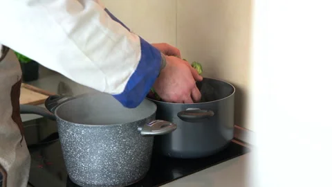 Chef putting broccoli in to the boiling water Stock Footage 161161721