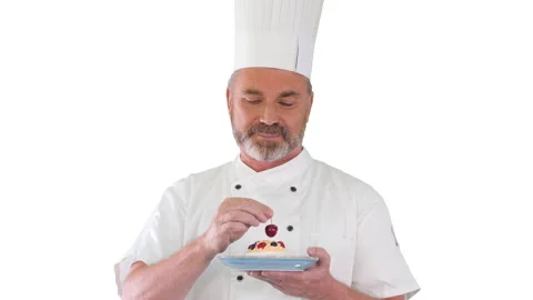 Chef putting cherry on top of the cake before serving it Icing on the cake on 動画素材 139147200