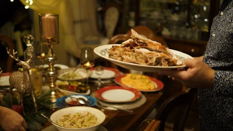 Chef putting dish with baked Turkey on dinner table. Christmas dinner. Stock Footage 129046652