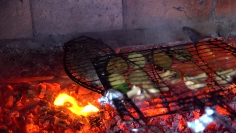 Chef is putting the fish and vegetables on the fire Stock Footage 73954515