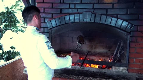 Chef is putting the fish and vegetables on the fire Video stock 73954533
