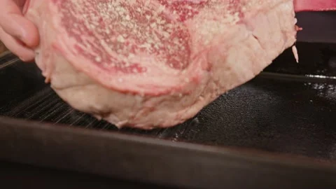 A chef is putting on a grill a tomahawk steak Stock Footage 201110257
