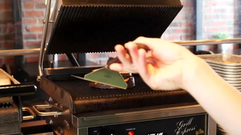 Chef putting a grilled cheese into a grilling machine 库存影片 201894991