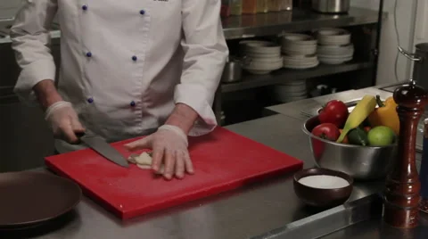 Chef putting half rings of onion into a plate, medium shot Stock Footage 66061907