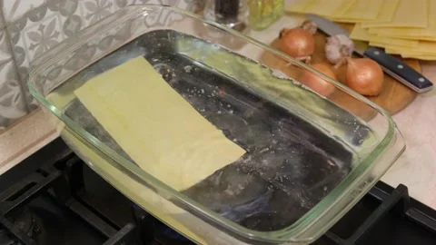 Chef putting lasagne sheets into boiling pot Stock Footage 146139982