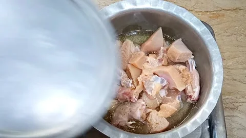 Chef Putting Lid on Chicken Pot, Tenderizing and Cooking Process, Meal Stock Footage 323351879