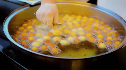 A chef is putting little Turkish donuts for baking. Video stock 152956830