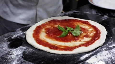 Chef putting mozzarella cheese on a pizza Stock Footage 71583071