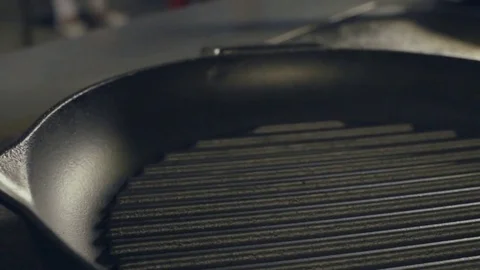 Chef putting oil to pan, close up Stock Footage 70393841