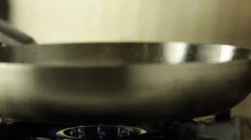 Chef Putting Pasta in a Pan with Sparkling Oil Stock Footage 86137945