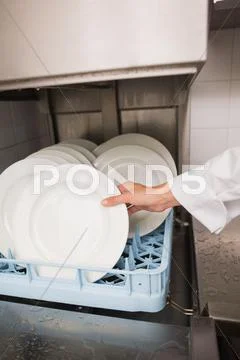 Chef Putting Plates In Drying Rack