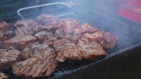 Chef is putting raw meat on grill. Barbecue meat preparing on grill, close up Stock Footage 75549738