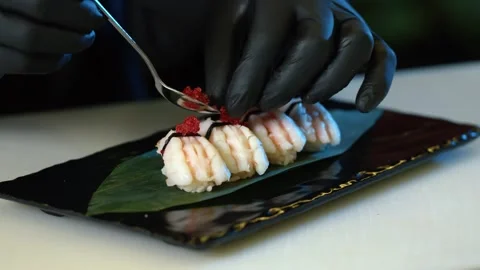 Chef Putting Roe red Sushi Caviar On Top Of Shrimp Tempura Sushi Video stock 239096735