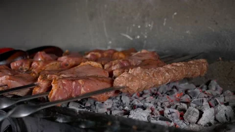 Chef is putting skewers with meat on the grill over charcoal. Stock Footage 150482953
