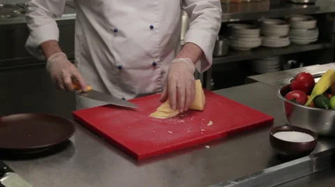 Chef putting sliced cheese into the plate, medium shot Stock Footage 66075035
