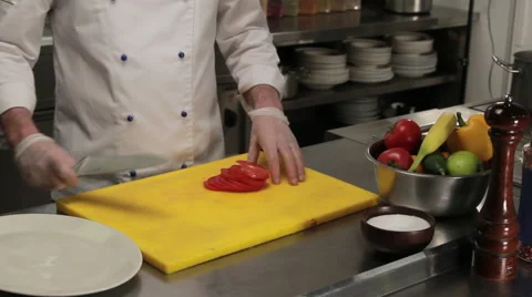 Chef putting sliced tomato on a plate, medium shot Stock Footage 66074484