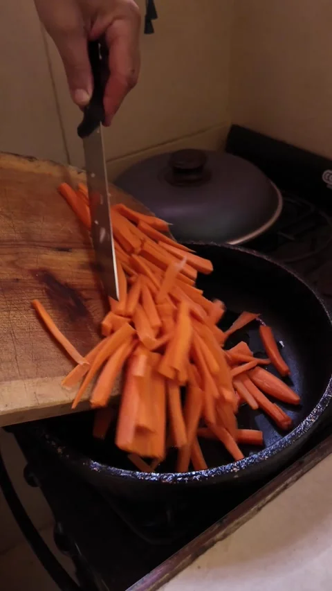 Chef putting sliced vegetables into a cooking pan Stock Footage 328876658